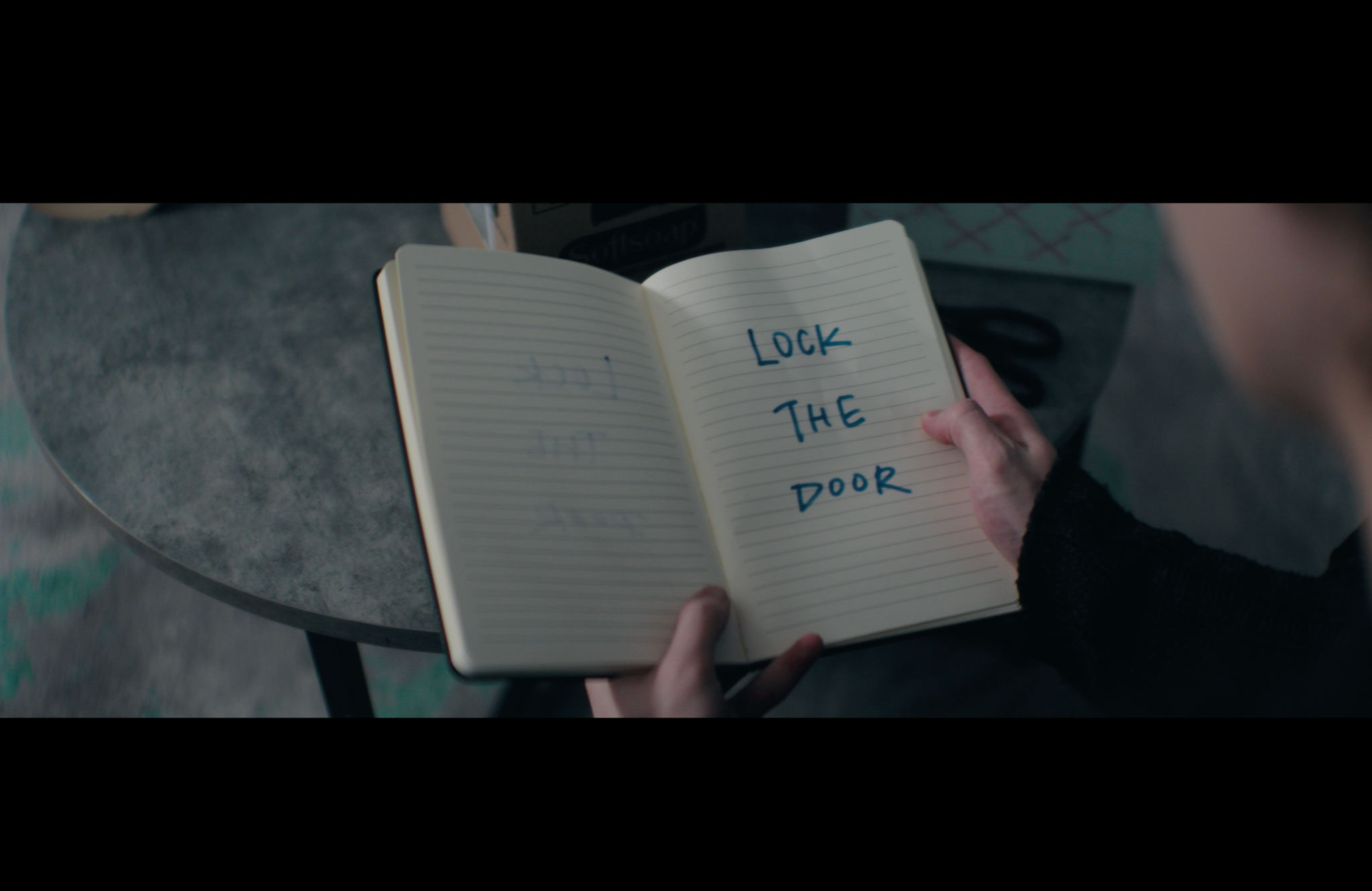 An open notebook with the words Lock The Door